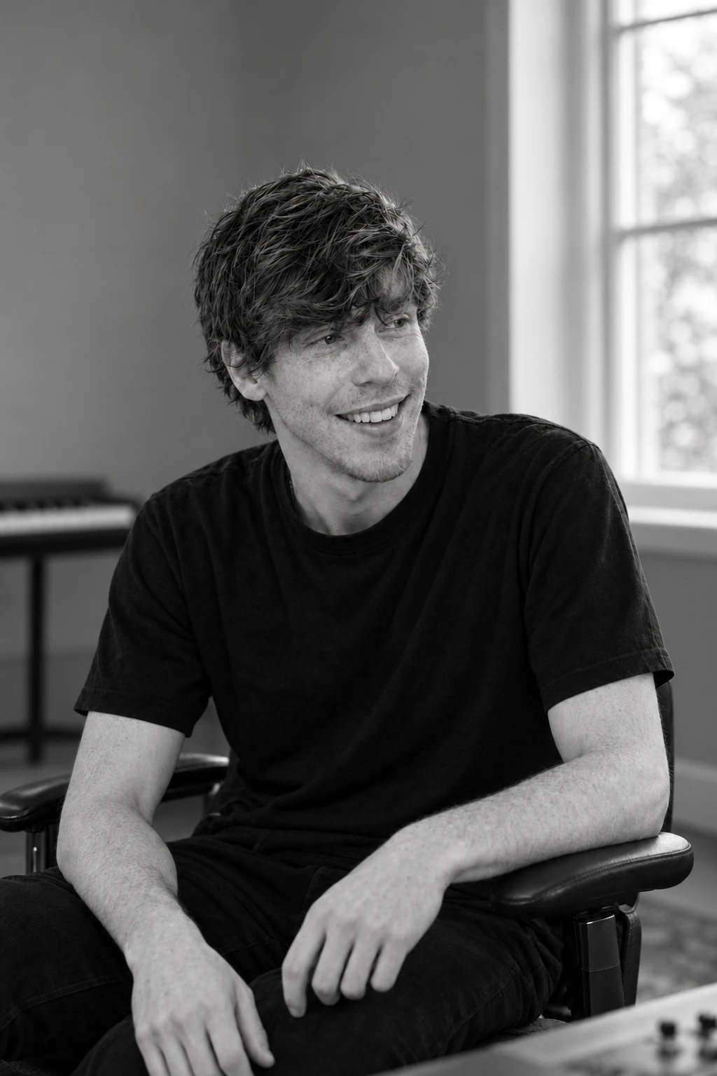 Sam Welch smiling during a conversation in the studio